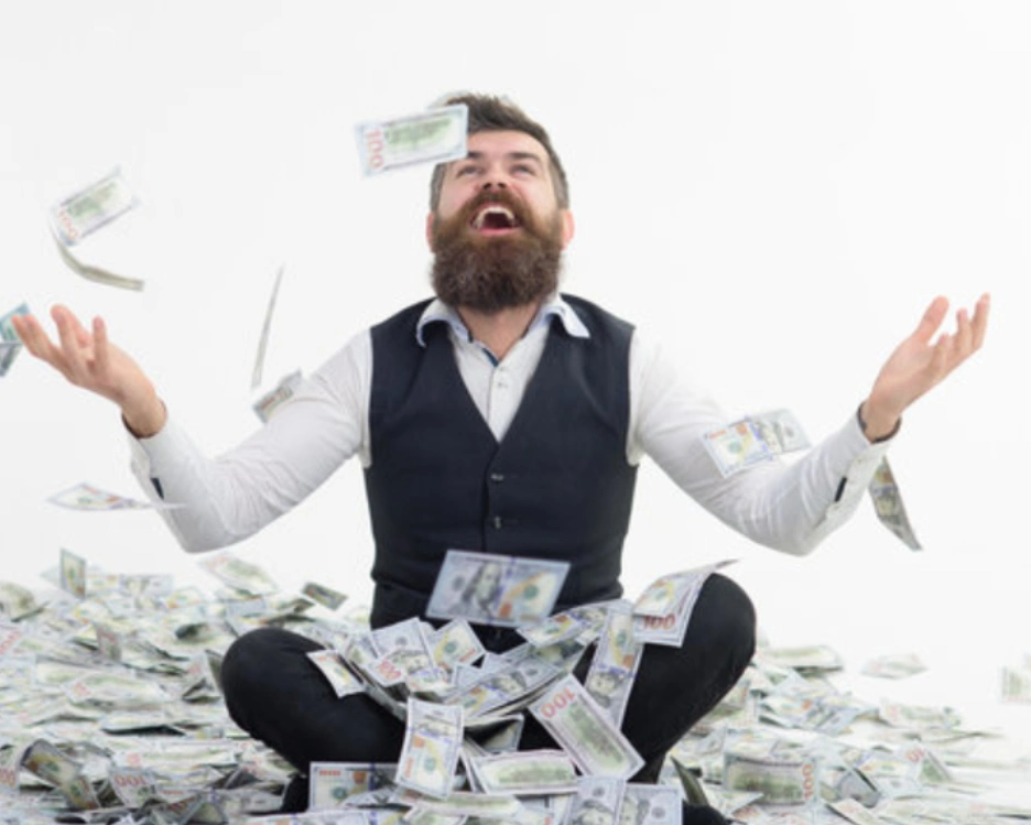 A man sitting on the ground with money in his hands.